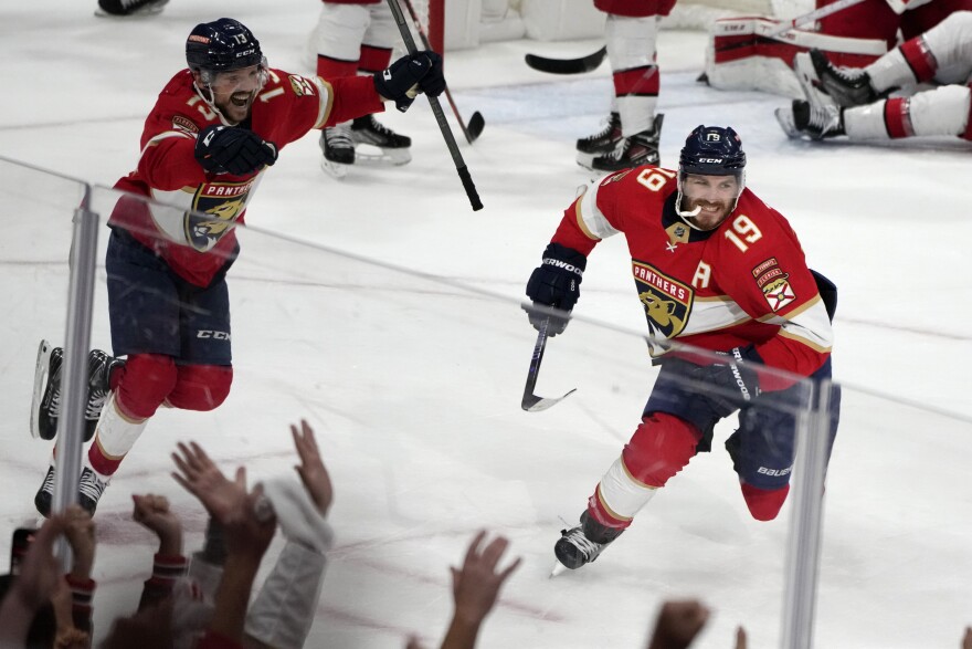 Florida Panthers left wing Matthew Tkachuk (19) reacts after scoring the game-winning goal against the Carolina Hurricanes in the waning seconds of the third period of Game 4 of the NHL hockey Stanley Cup Eastern Conference finals Wednesday, May 24, 2023, in Sunrise, Fla. At left is Panthers center Sam Reinhart (13).