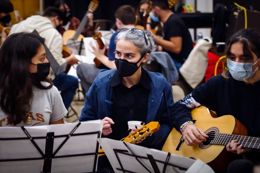 People wearing masks playing guitars