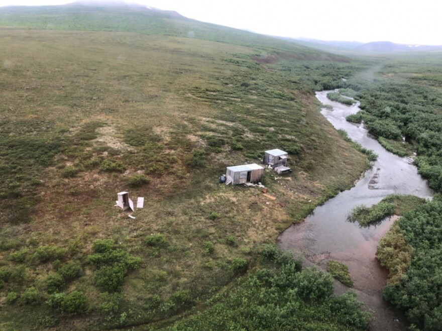 While flying over Alaska from Kotzebue to Nome, a Coast Guard aircrew spotted an SOS sign on top of a shack and a man waving his hands in the air.