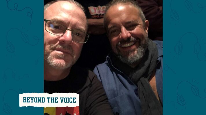 Two men smiling