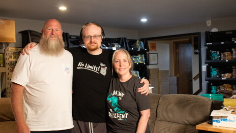 Trent Landreth (middle) is the creator behind Drawings by Trent. His mother (right) and father (left) help with him record his viral drawing videos and manage his business.