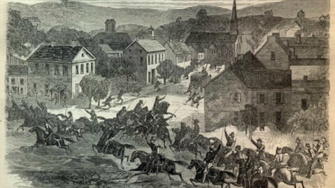 A 19th-century engraving depicting Confederate cavalry troops under General John Hunt Morgan riding aggressively on horses through the streets of Washington, Ohio, during an 1863 Civil War raid.