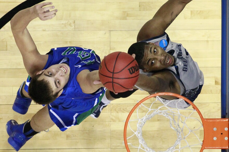 Florida Gulf Coast's Chase Fieler (left) and Georgetown's Mikael Hopkins leap for a rebound during a second-round game of the NCAA tournament Friday.