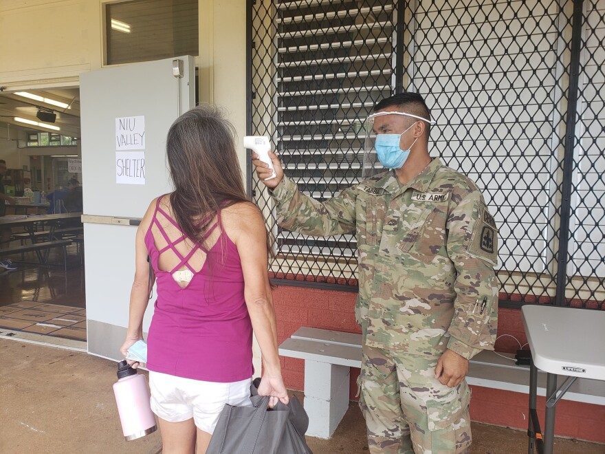 PFC Makana Tabbal conducting a temperature screening at the Oʻahu Niu Valley Middle School hurricane shelter in Hawaii Kai in July 2020.