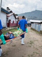 Medical workers transfer a patient from the Doctors Without Borders cholera treatment unit to the intensive care unit at the general hospital in Masisi, Democratic Republic of Congo.