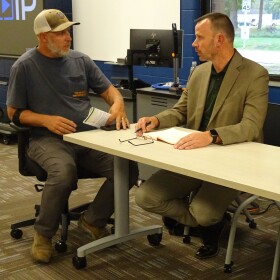 Roger Kriedeman (left) conferring with DNR drinking and groundwater scientist Kyle Burton at September 11 public meeting. Kriedeman is building his forever home just outside the area Johnson Controls considers to be its responsibility.