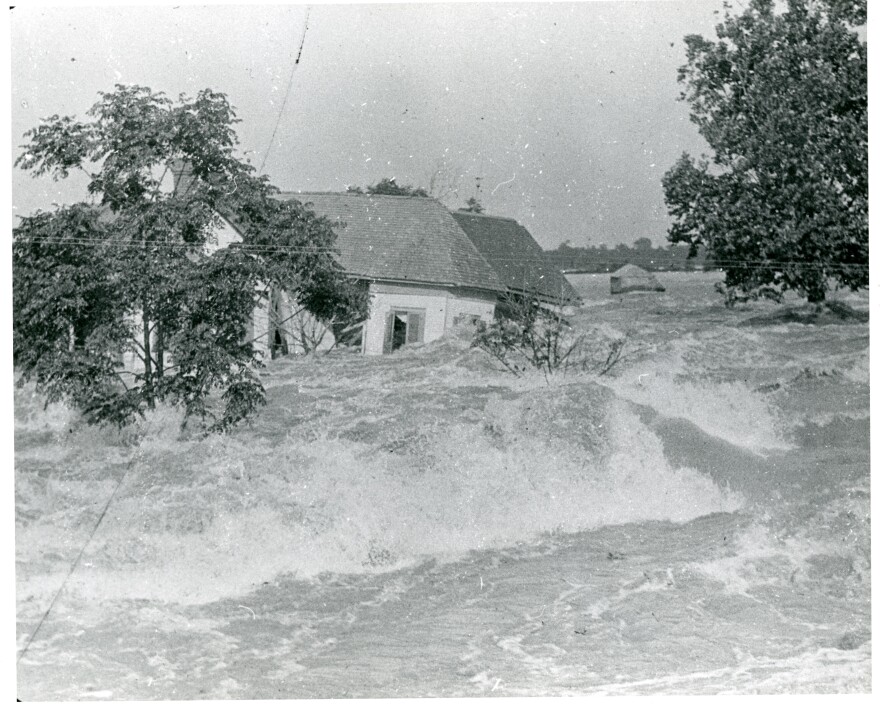 A house is swept away by torrential floodwaters in the Great Mississippi River Flood of 1927. The precise location where this archival photograph was taken is unknown.