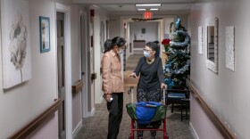 A nursing home resident speaks with a staff member.