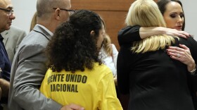 Florida Circuit Judge Elizabeth Scherer hugs Jennifer Guttenberg following the sentencing hearing for Parkland school shooter Nikolas Cruz at the Broward County Courthouse in Fort Lauderdale, Fla., Nov. 2, 2022. 