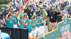 Members of the team from Latin America cheer during the Little League World Series parade in downtown Williamsport on Tuesday.