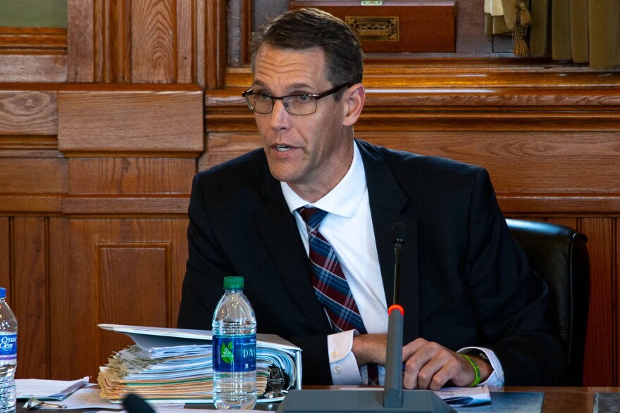 Representative Randy Feenstra sits at a desk.