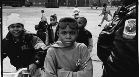 Image of young black kids in Chicago with a police officer.