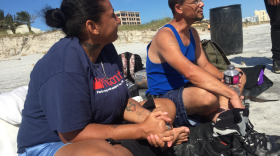 Jacksonville Beach resident Patrick Verwey and his wife, Nancy Luciano, sit on the beach Sunday after losing their home in Hurricane Matthew.