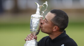Xander Schauffele of the United States kisses the Claret Jug trophy after winning the British Open Golf Championships at Royal Troon golf club in Troon, Scotland, Sunday, July 21, 2024. (AP Photo/Peter Morrison)