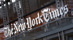 FILE - A sign for The New York Times is displayed above the entrance to its building in New York on May 6, 2021. (AP Photo/Mark Lennihan, File)