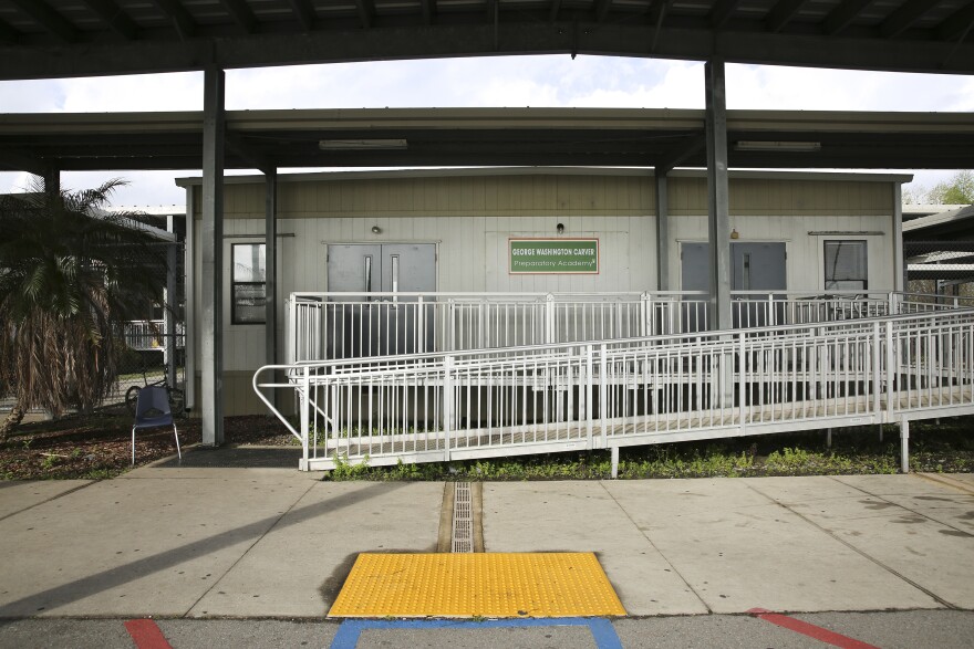 Carver Prep is housed in a small compound of temporary trailers with covered walkways in between. A new school building is under construction next door.