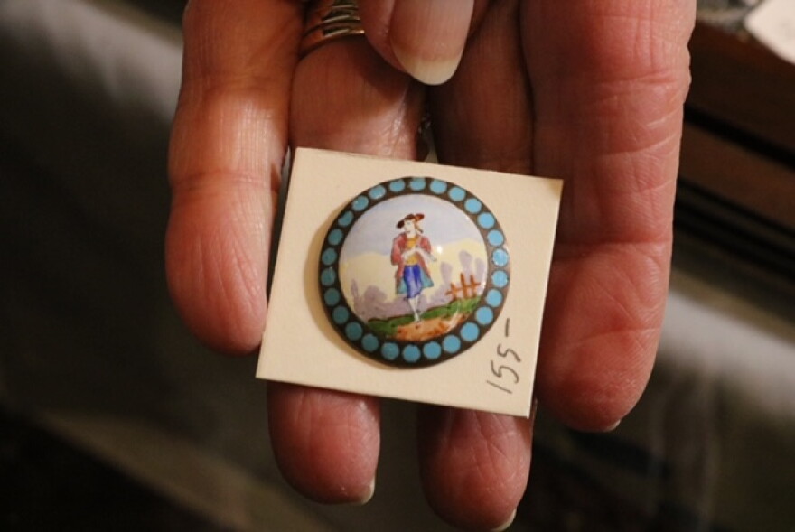 A popular favorite by button collectors are hand painted enamel buttons, like the one pictured for $155.