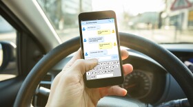 A person texting while driving 