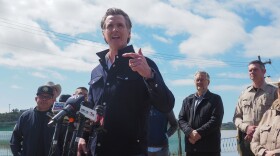 Gov. Gavin Newsom stands in front of flooded farm fields in Pajaro, CA and affirms that help from the state will continue. "You have my word on that," he said.
