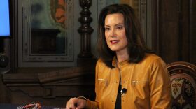 Governor Gretchen Whitmer sitting at a desk