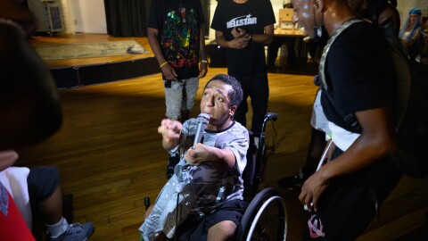 Bridgeport artist Carlos De Los Santos, who performs as NDO Hotwheelz, performs during Underground Mass Chaos in Bridgeport, Conn., as audience members gather around him.