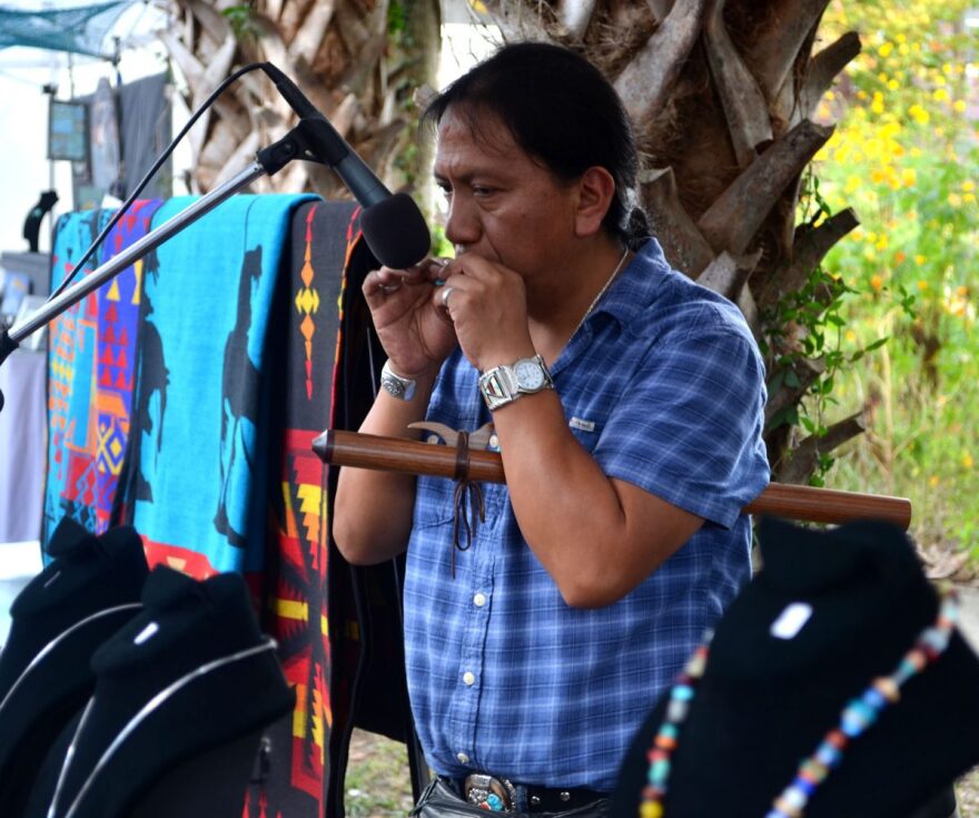 Carlos Vegas performs at this tent at Micanopy Fall Festival. He came to Micanopy from Nashville to sell jewelry from The Wind Native American Art. (Nicole Dan/WUFT News)