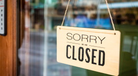 sign on a restaurant door says sorry we're closed.