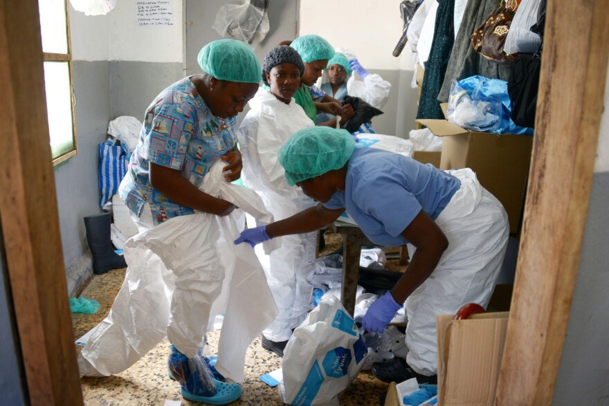 Medical workers at the John F. Kennedy Medical Center in Monrovia, Liberia, put on their protective suits before going to the high-risk area of the hospital, where Ebola patients are being treated, Sept. 3.