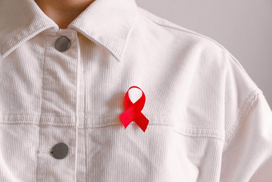 Red ribbon on a white shirt.