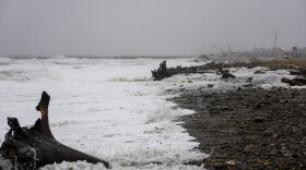 Waves, driftwood and foam cover the shore in Nome as a slow-moving Bering Sea storm pummeled the Western Alaska coast on Oct. 23, 2026.