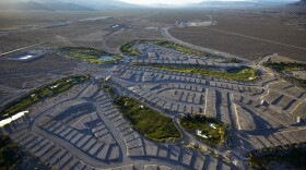 In this June 16, 2016, photo, shrubs grow on empty housing pads at the Coyote Springs golf course in the Coyote Springs development, about 50 miles northeast of Las Vegas. Before the housing bubble burst, developers planned to create a new community in the desert with thousands of homes, several golf courses and other amenities. But the housing bubble burst, with only the golf course completed before the project stalled. (AP Photo/John Locher)