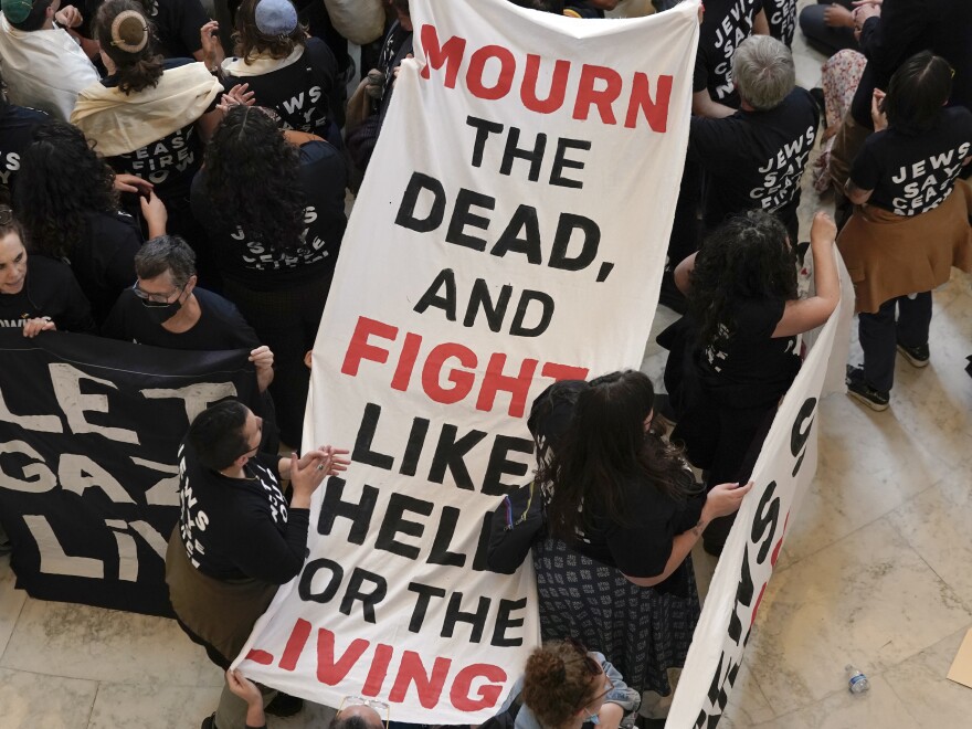 Demonstrators protest inside the Cannon House Office Building on Capitol Hill in Washington, D.C., on Wednesday, Oct. 18, 2023.