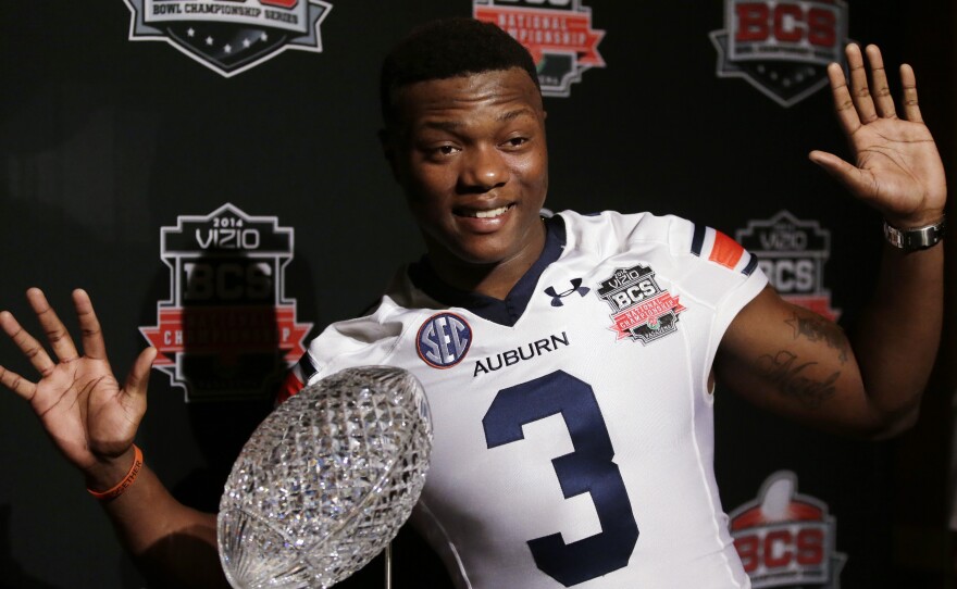 Look, But Don't Touch, Part II: Some players are superstitious and don't want to touch a trophy until they win it. Auburn wide receiver Dominic Walker poses with the NCAA's Coaches' Trophy, which goes to the winner of Monday night's game.