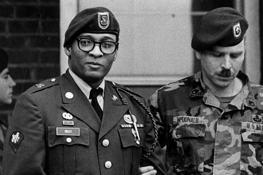 Spec. Ronald A. Gray, pictured leaving a Fort Bragg courtroom escorted by military police in April 1988. (Marcus Castro/The Fayetteville Observer/AP)