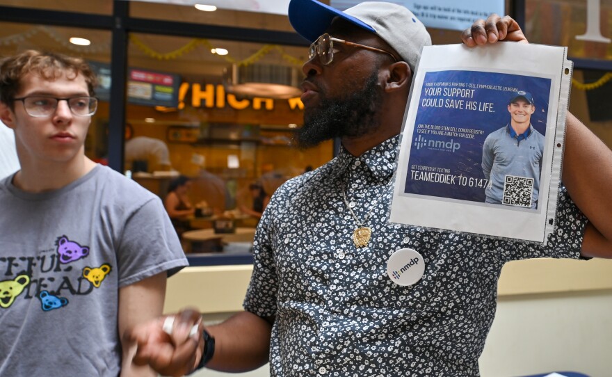 Houston Roberson from NMDP holds up a flyer for Eddie Kaufman, a 20-year-old old Mid Valley School District graduate, in need of a bone marrow match.
