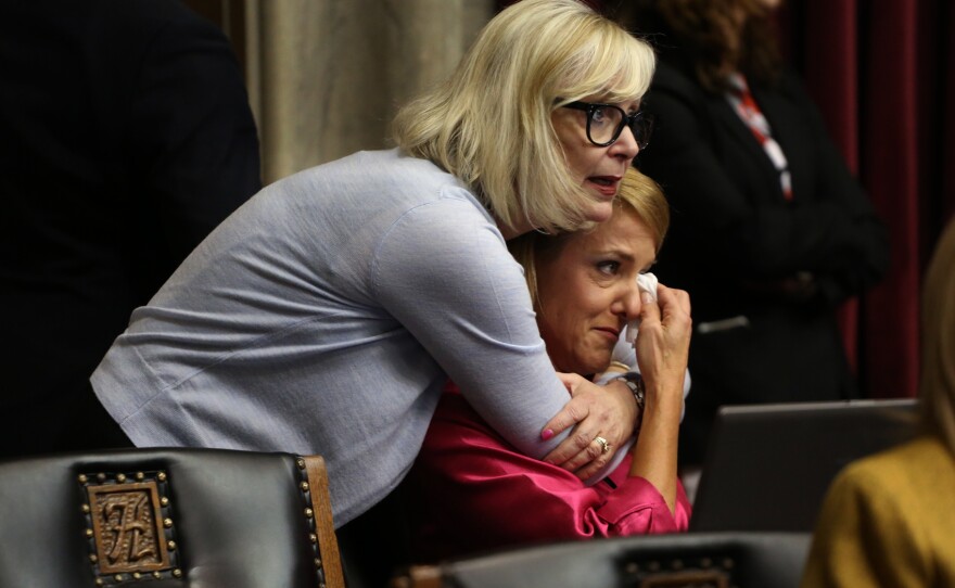 Rep. Stacey Newman, D-Richmond Heights, comforts Rep. Tracy McCreery, D-Olivette, after McCreery spoke on the what she called the hypocrisy of fellow representatives' desire to limit gun control while voicing concerns about suicide.