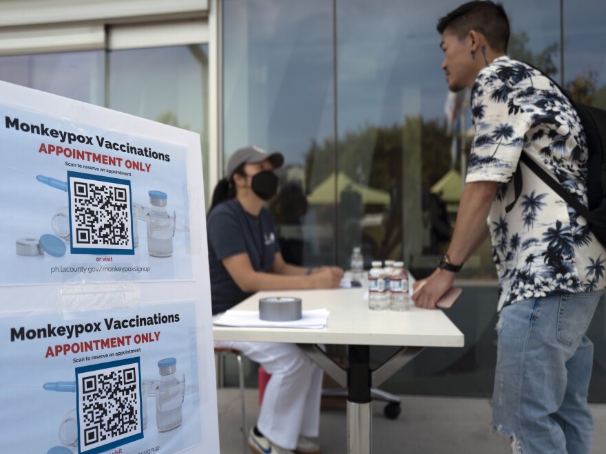 A visitor checks in at a Pop-Up Monkeypox vaccination site at the West Hollywood Library on Wednesday, Aug. 3, 2022, in West Hollywood, Calif. The City of West Hollywood is working with public health officials at the Los Angeles County Department of Public Health in responding to the monkeypox outbreak. (AP Photo/Richard Vogel)