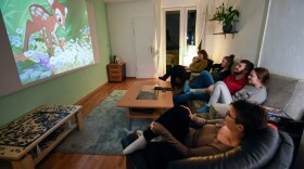 Members of a flat-sharing community watch the 'Bambi' film of Disney at their living room, in Dortmund, western Germany, on March 27, 2020, amidst the pandemic of the new coronavirus COVID-19. (INA FASSBENDER/AFP via Getty Images)