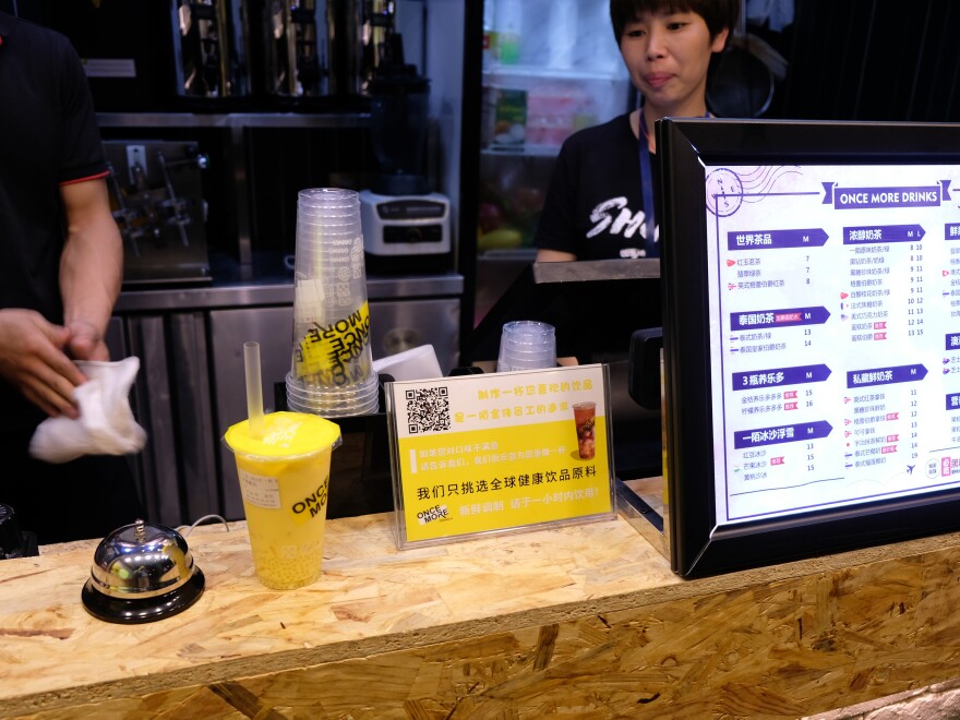 A juice shop in east Hangzhou displays a QR code next to the menu, allowing customers to pay with mobile payment apps on their smartphones.