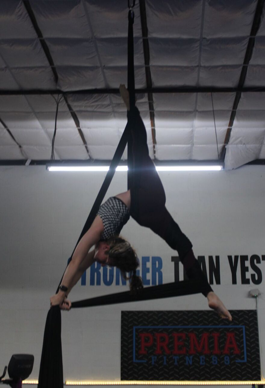Fit to Fly silk aerialist Sarah Waitekus perfoms inversion.