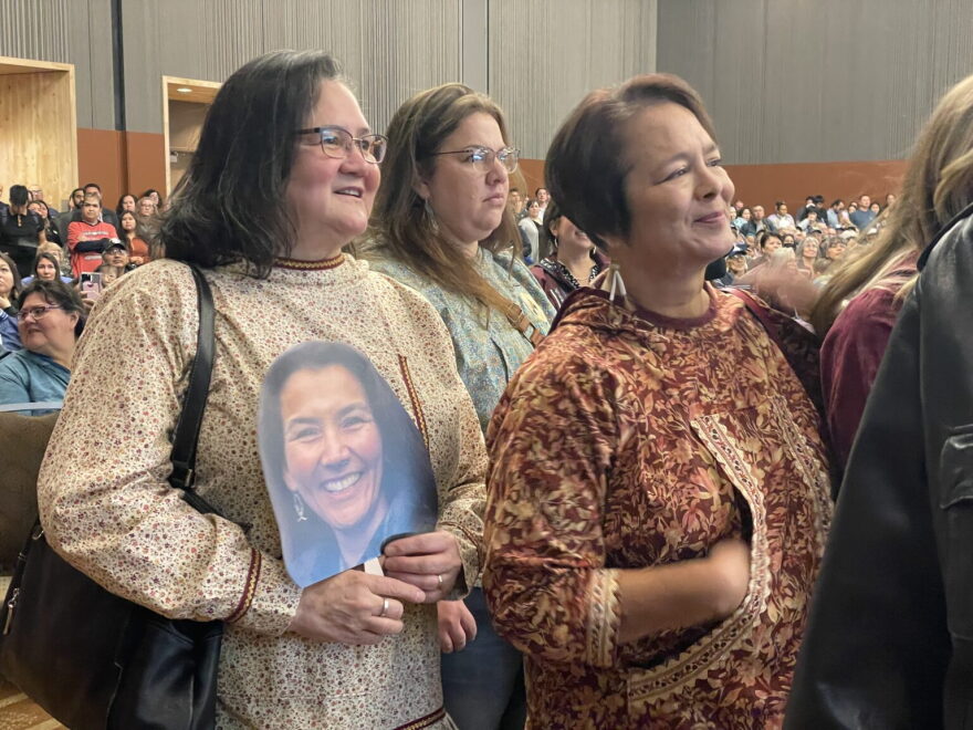 The daughters of the late Congressman Don Young say they support Mary Peltola’s re-election. Joni Nelson, left, holds Peltola’s photo. In front of her is her sister, Dawn Vallely.