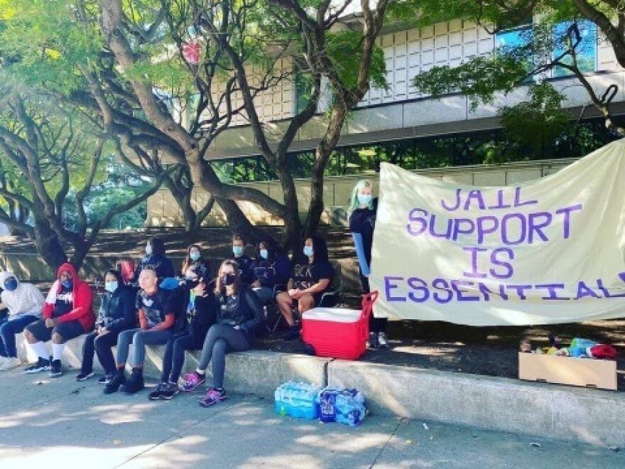  2020 Jail support volunteers stand across the street from the Mecklenberg county courthouse waiting to provide resources to newly released citizens. 