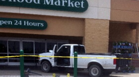 Placards mark the shell casings outside a crashed pick-up at the 21st and Yale Wal-Mart grocery store.
