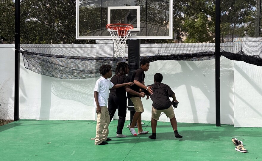 Middle schoolers play basketball with a sneaker at Lotus House's Children's Village, a new child education and resource center in Overtown on Nov. 6, 2025.