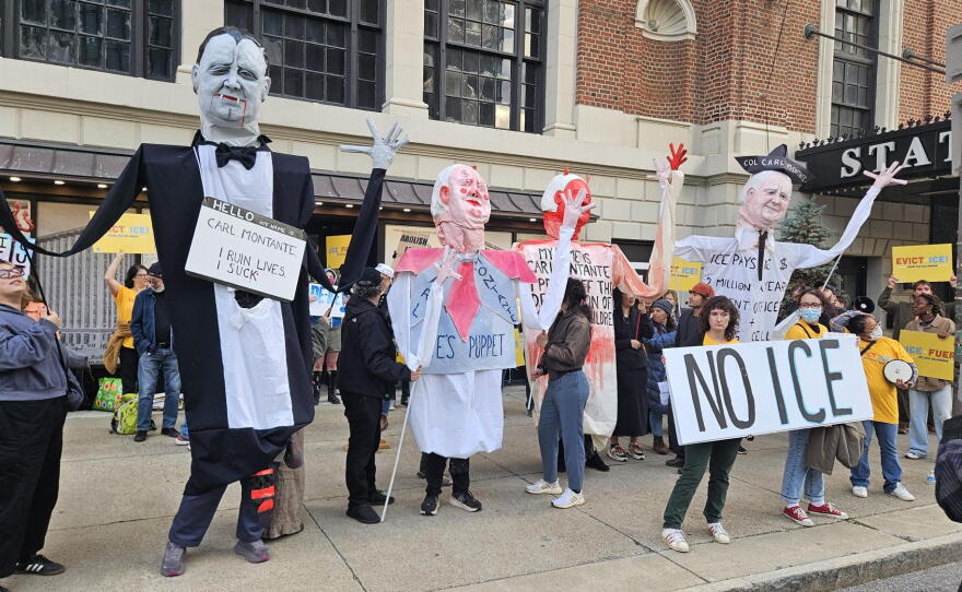 Protesters stand outside the Statler Building, calling for Carl Montante to end rental agreements with ICE