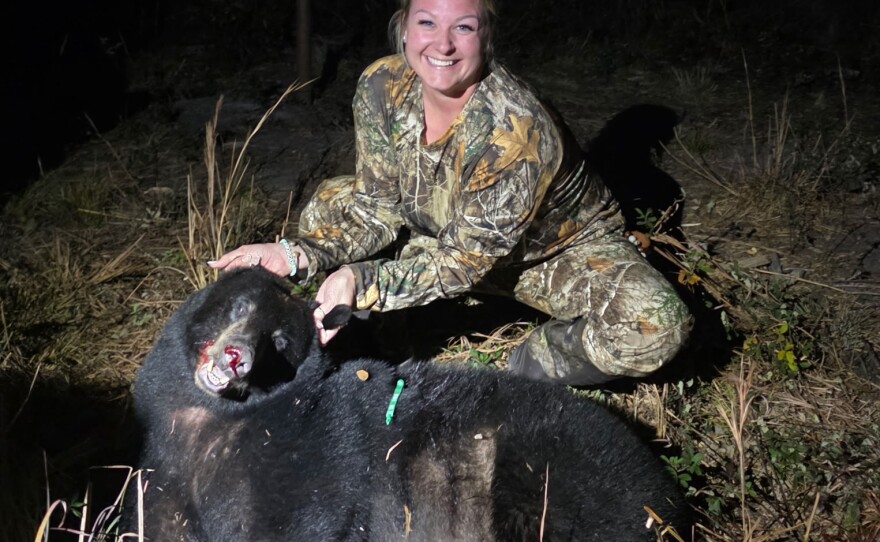 Ashlyn Croff holds up the Florida black bear she shot Dec. 23, 2025, in Wewahitchka, Fla. Croff, 33, sent the bear to a taxidermist for a full-body mount and won’t get her back until July: “I’m super excited to get her back and see what she looks like.” (Contributed/Fresh Take Florida)