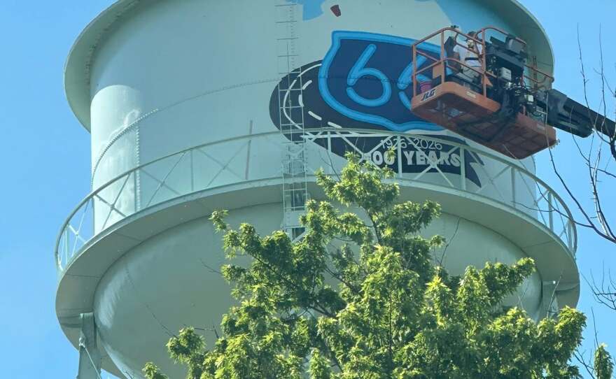 A photo from the ground of work being done on the water tower.