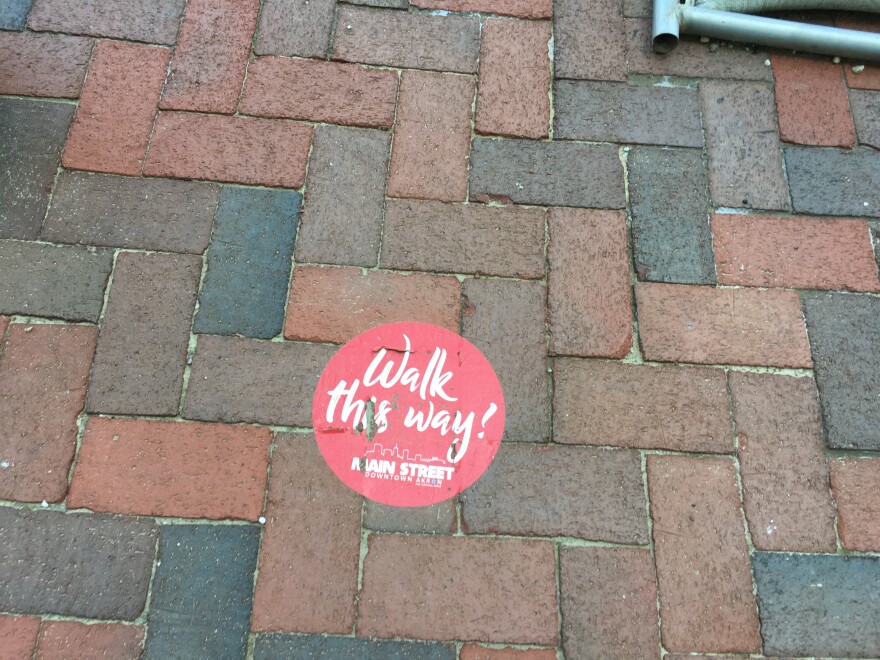 Directional dots on the sidewalk in downtown Akron