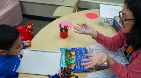 TK teacher Beatriz Amador speaks with a student in Spanish about an otter’s body.