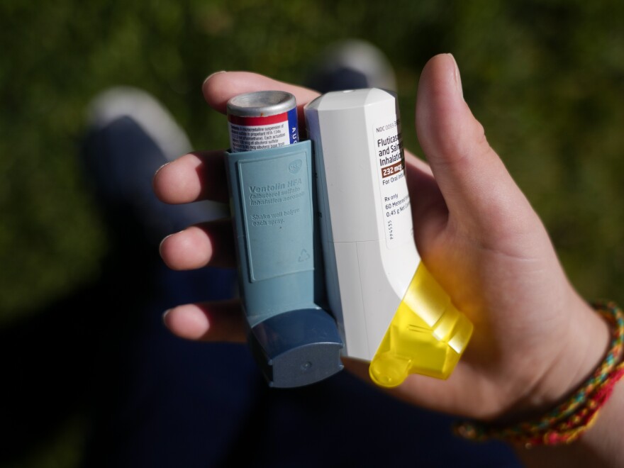 Oliver Loubet holds the two inhalers he needs to manage the multiple respiratory issues he lives with in Kearns on Friday, Oct. 13, 2023.